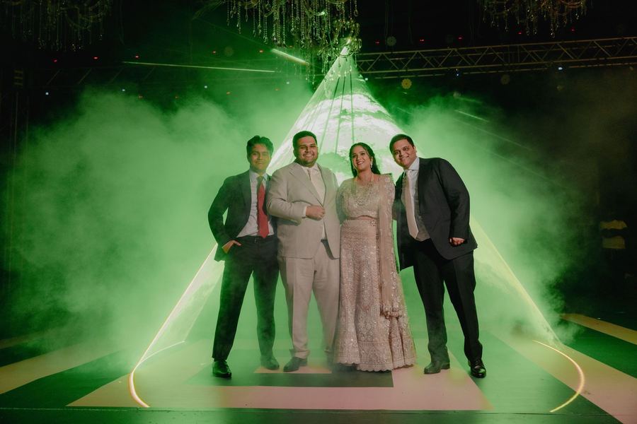 Hosts on stage in green haze