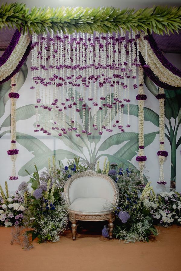 Jasmine and violet garland backdrop with a white chair