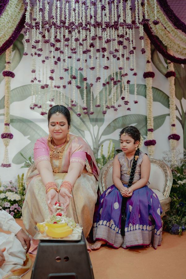 Mother and daughter at the ceremony before the garland backdrop