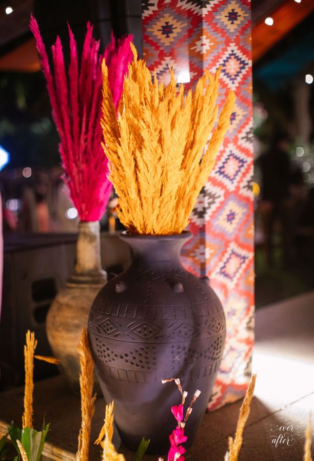 Dyed pampas in a carved clay urn
