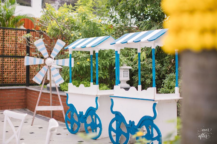 Blue and white striped cart bar with a windmill