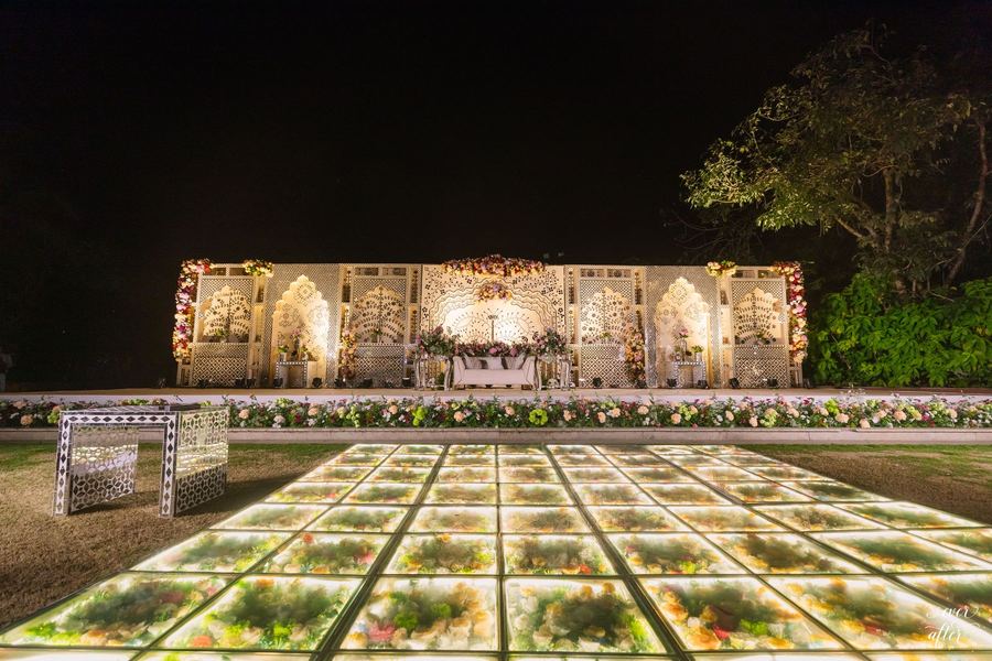 Illuminated glass walkway leading to the reception stage