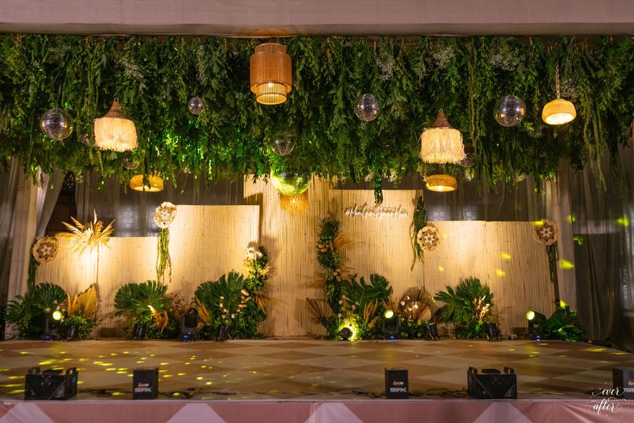Sangeet stage beneath a ceiling of ferns and rattan lanterns