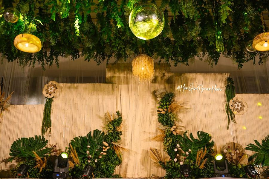 Tropical palms and ferns in front of a bamboo backdrop