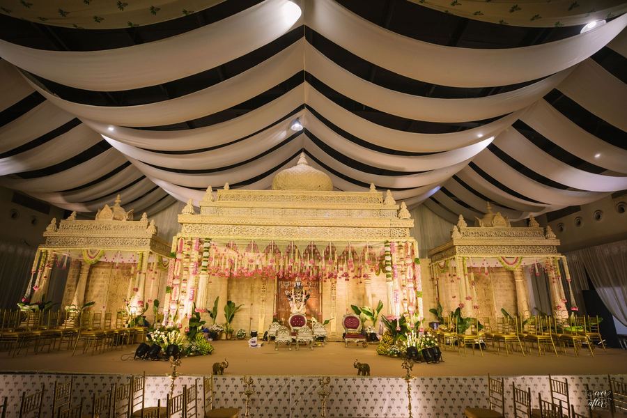 Ivory carved temple mandap under a white draped canopy