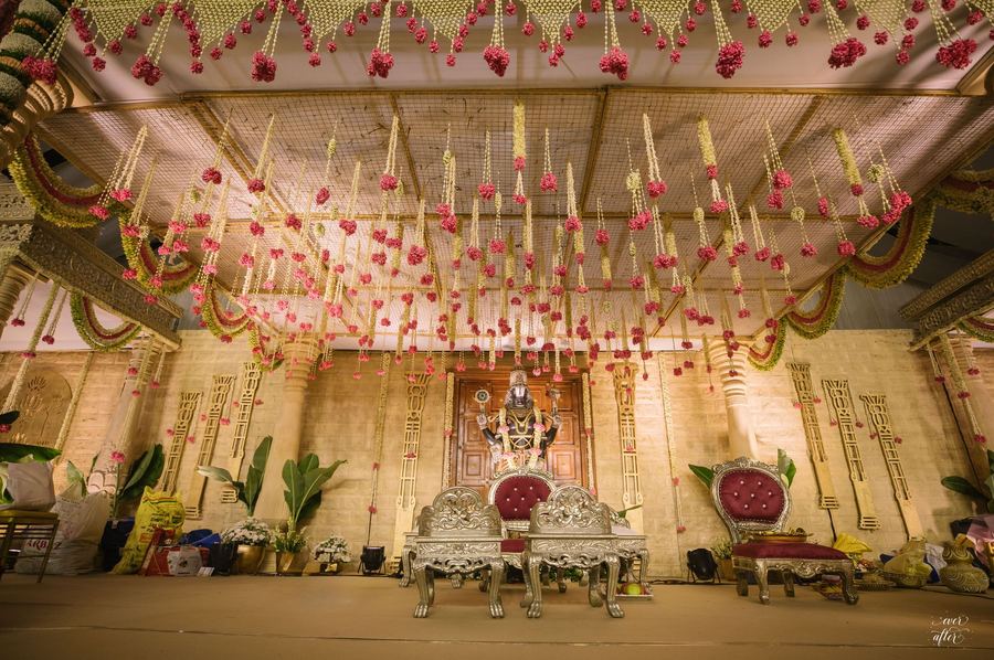 Ceremony stage under a ceiling of hanging pink rose strands