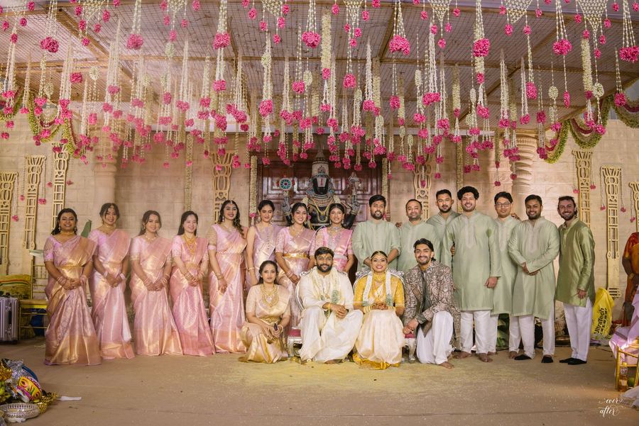 Wedding party gathered on the floral mandap