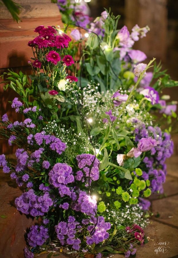 Tall arrangement of violet lisianthus and magenta blooms