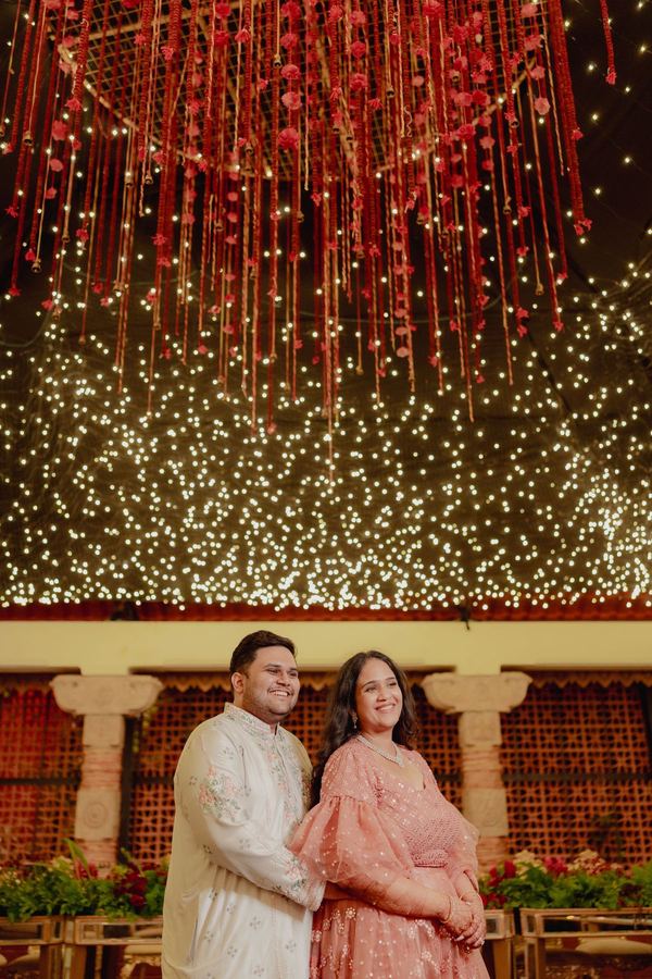 Couple beneath a ceiling of hanging lights