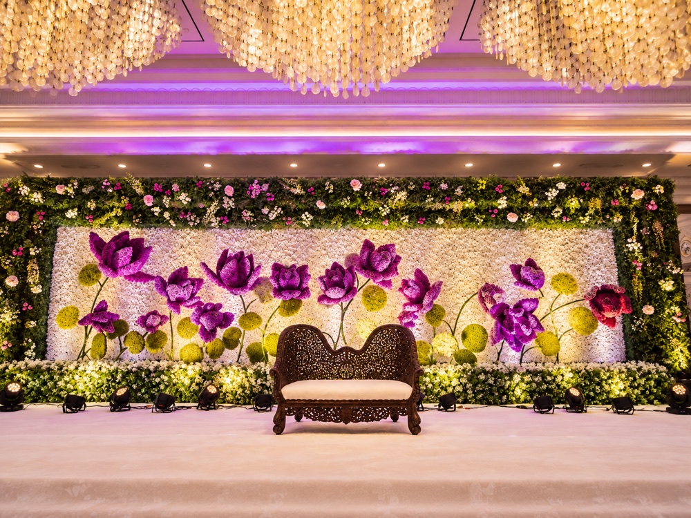 Ballroom stage with purple and white floral wall art